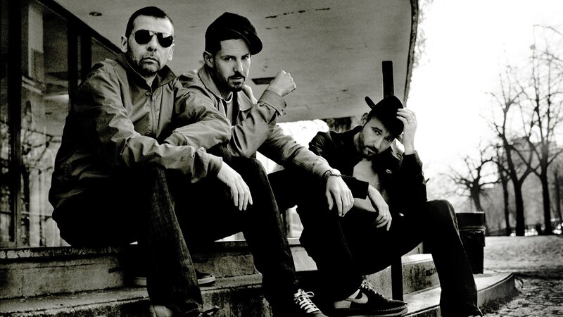 Three Men Sitting on Steps — Black