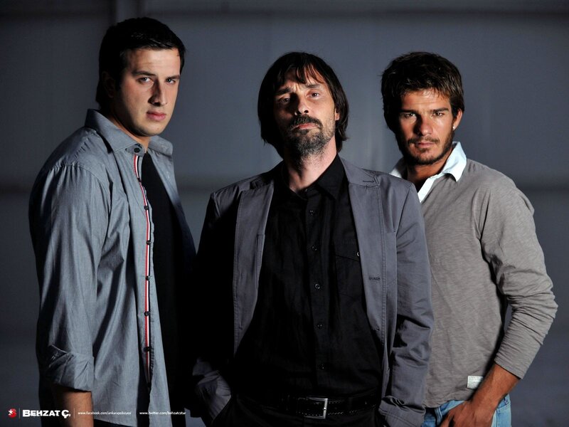 Three Men Standing — Gray, Serious