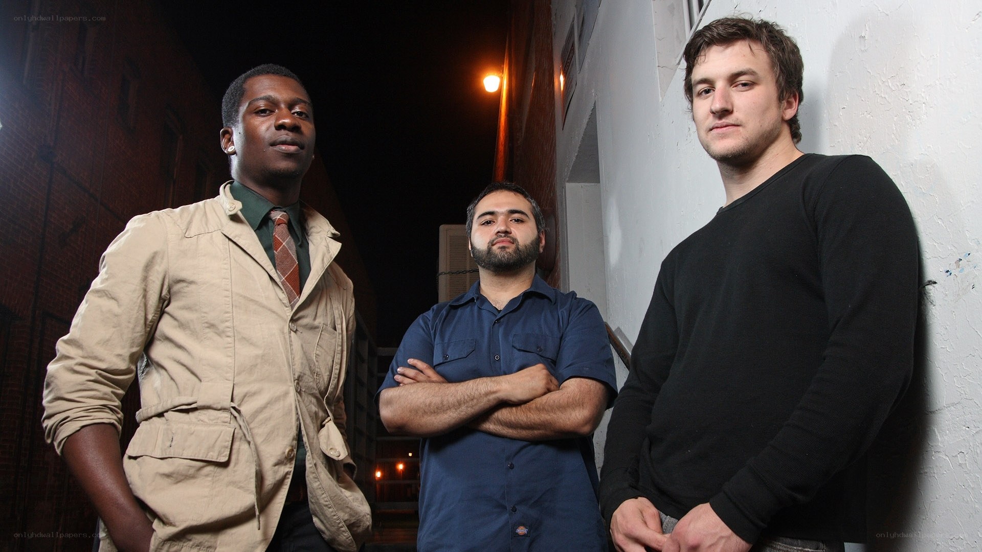 three men standing in alley