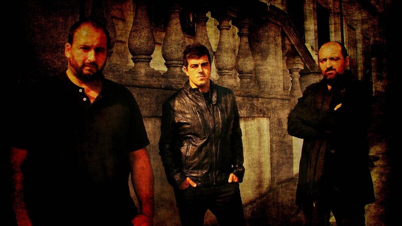 three men standing in front of stone railing