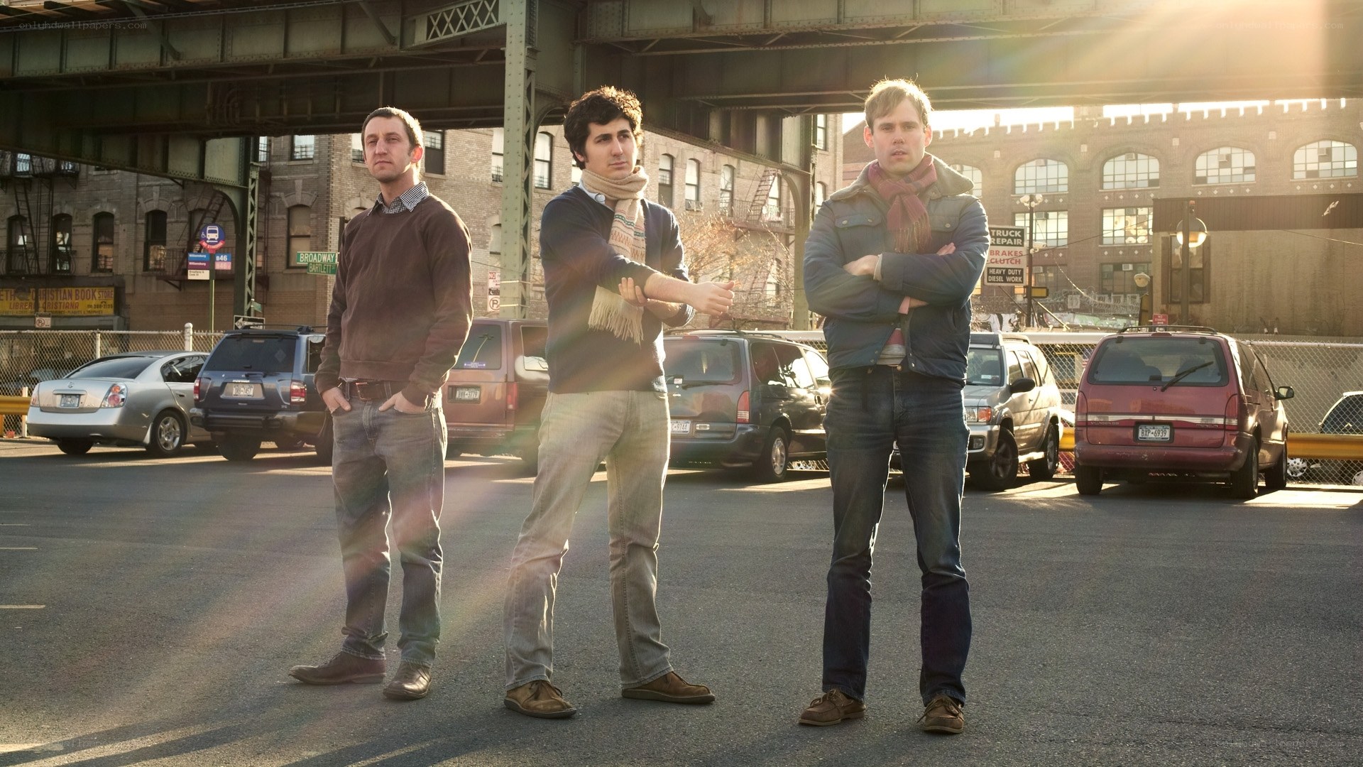 three men standing in parking lot