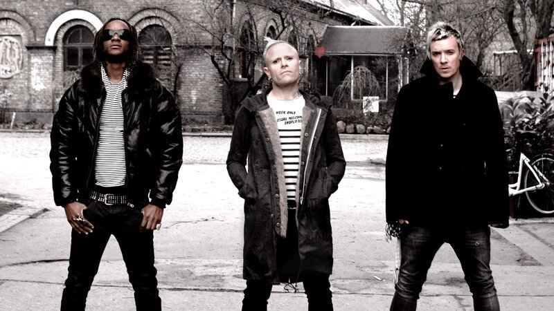 three men standing in street
