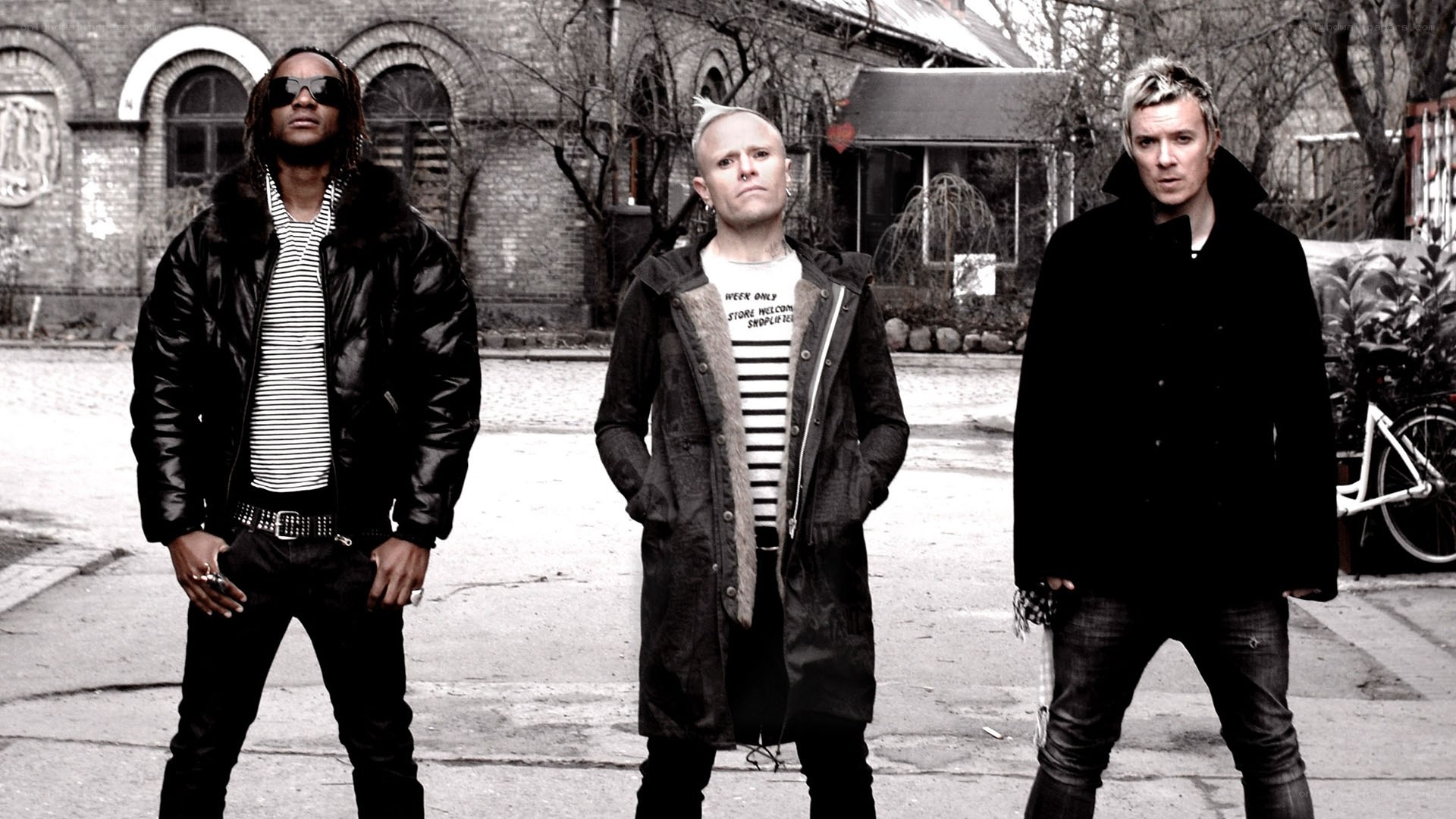three men standing in street
