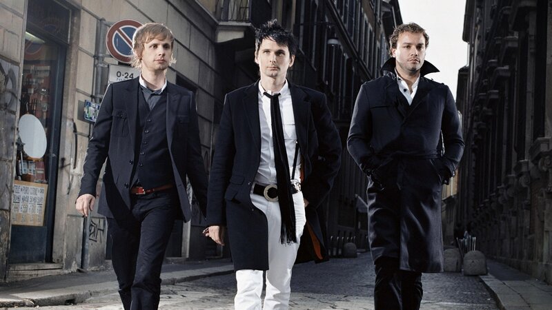 three men walking in city