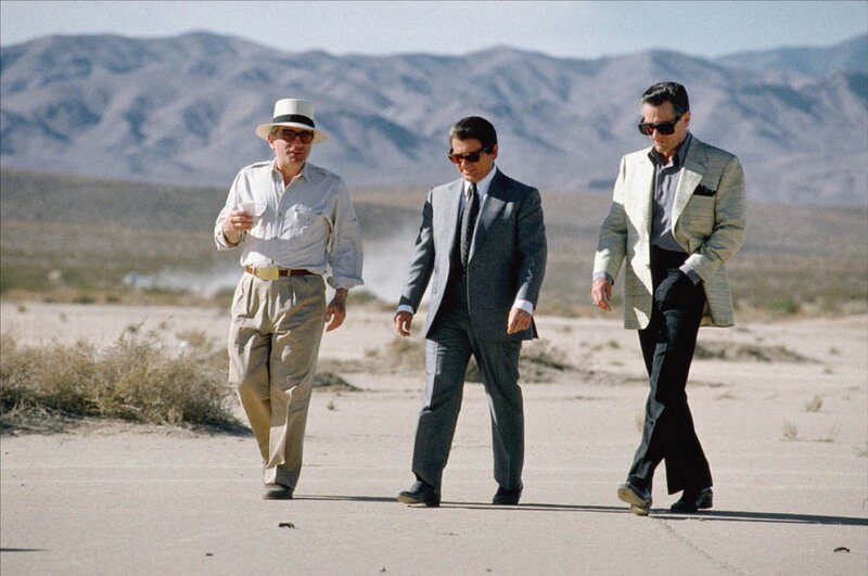 Three men walking in desert