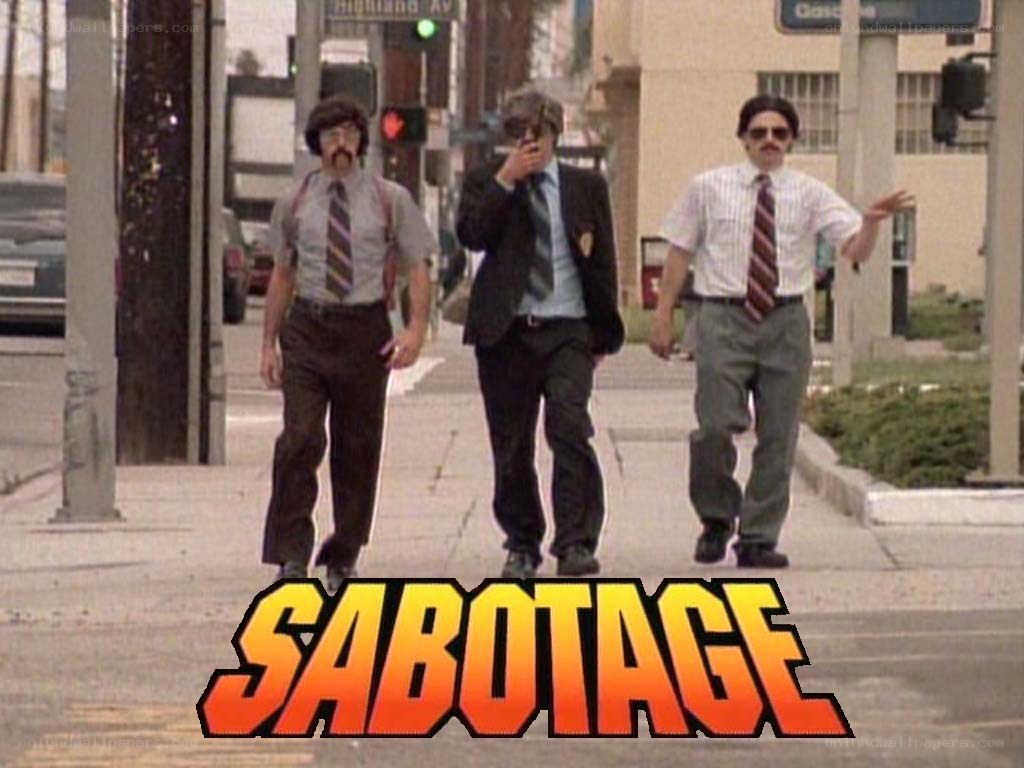 three men walking on sidewalk