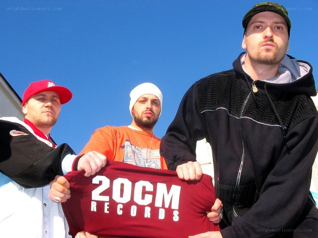 Three men with 20CM Records shirt