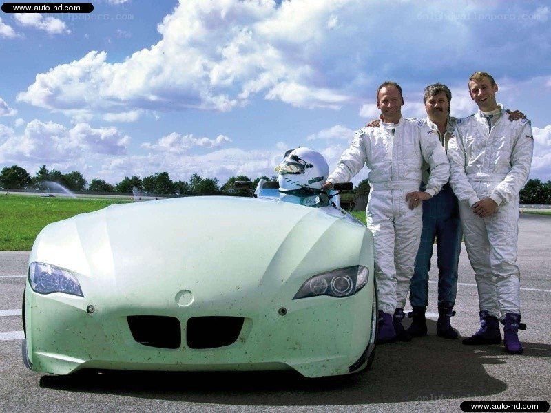 Three men with a race car