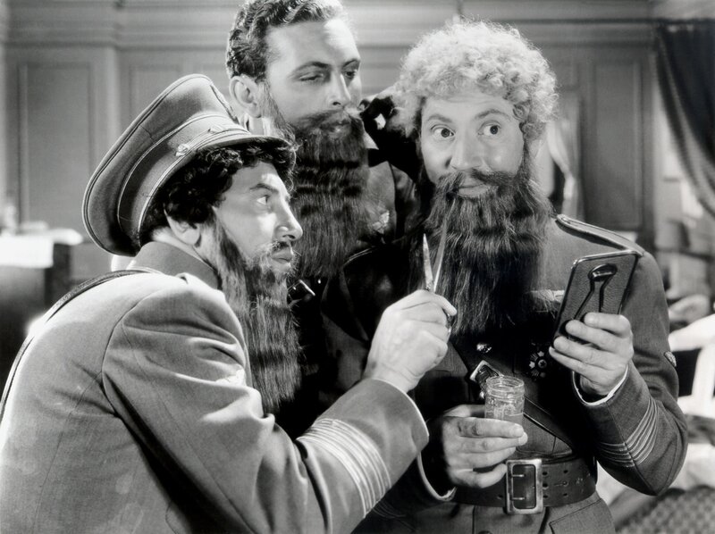 Three men with beards in military uniforms