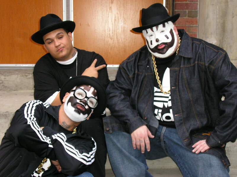 Three men with face paint posing