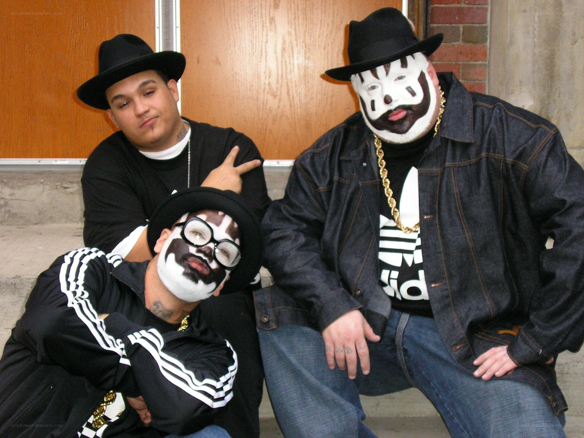 Three men with face paint posing