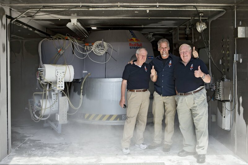Three men with spacecraft
