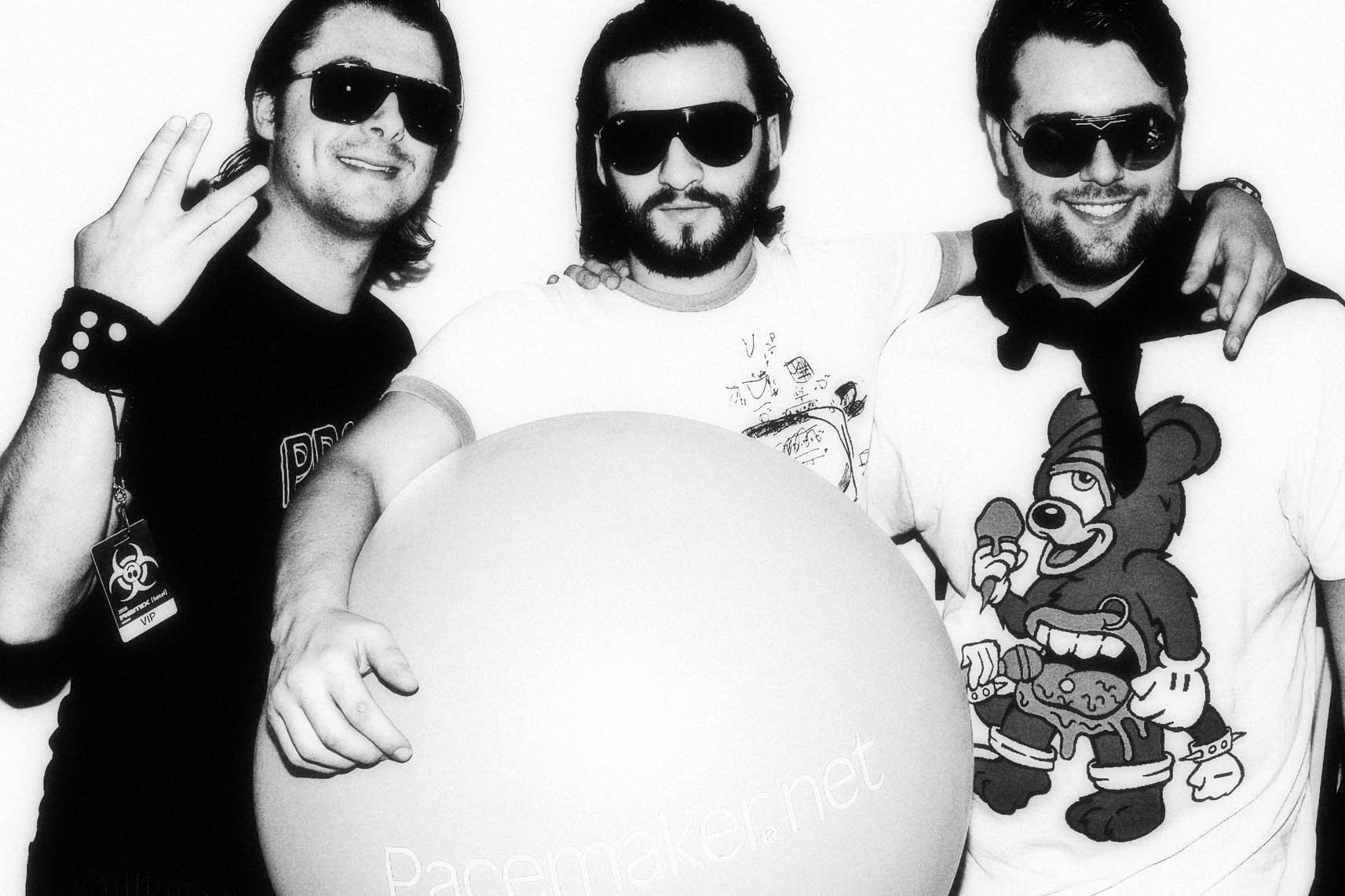 three men with sunglasses and balloon