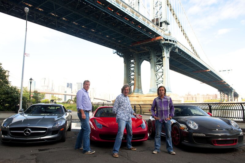 Three men with supercars under a bridge