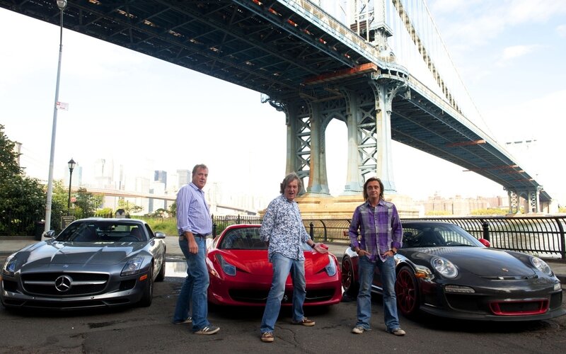Three men with supercars under a bridge