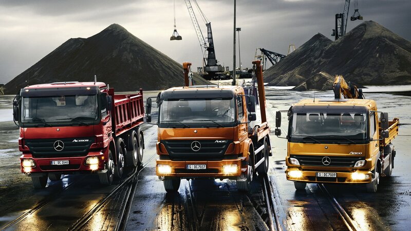 Three Mercedes-Benz trucks at a quarry