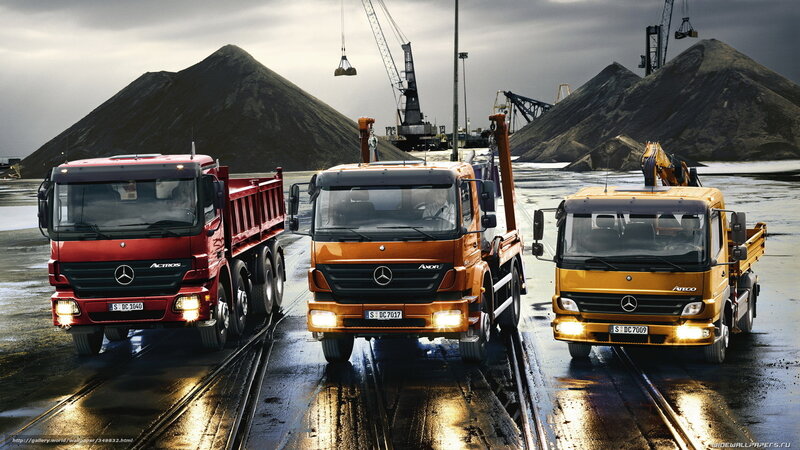 Three Mercedes-Benz trucks in a quarry