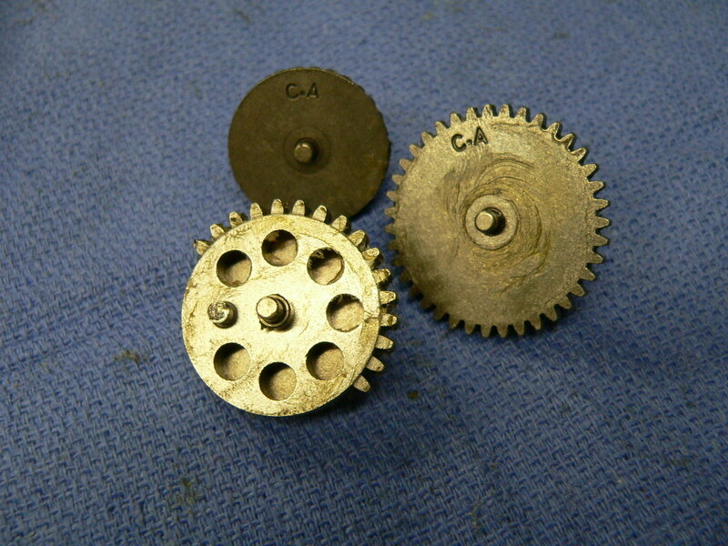 three metal gears on blue cloth