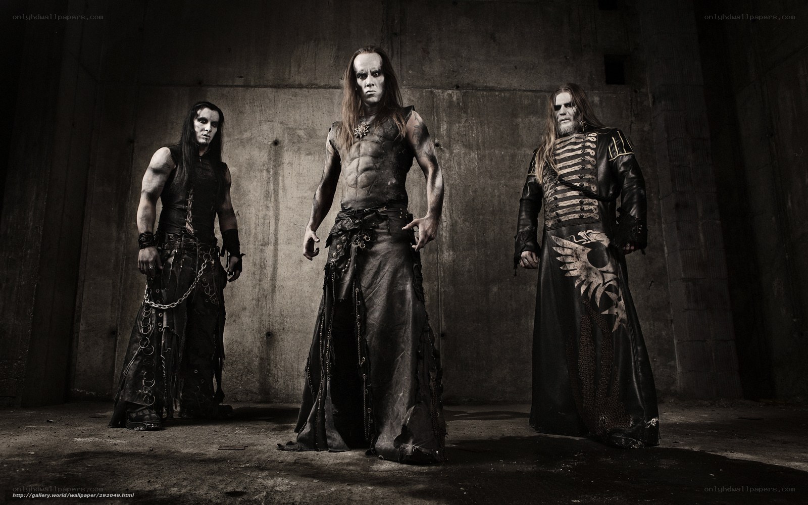 three metal musicians in dark attire