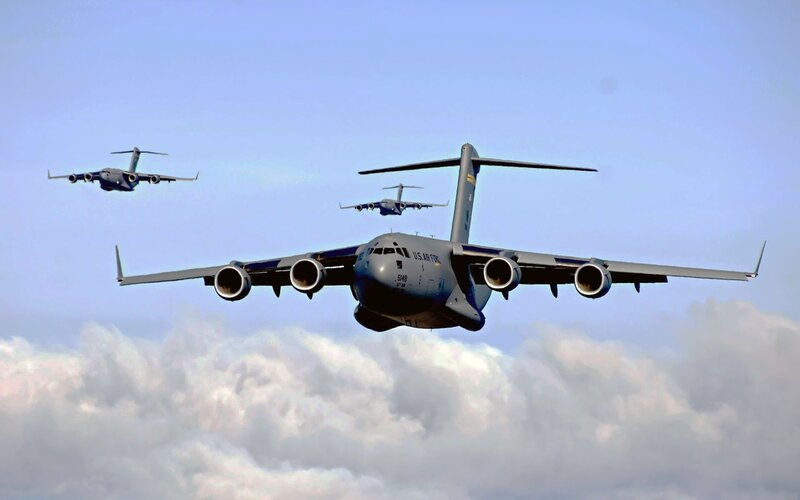 Three military transport planes in formation