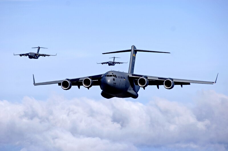 Three military transport planes in formation