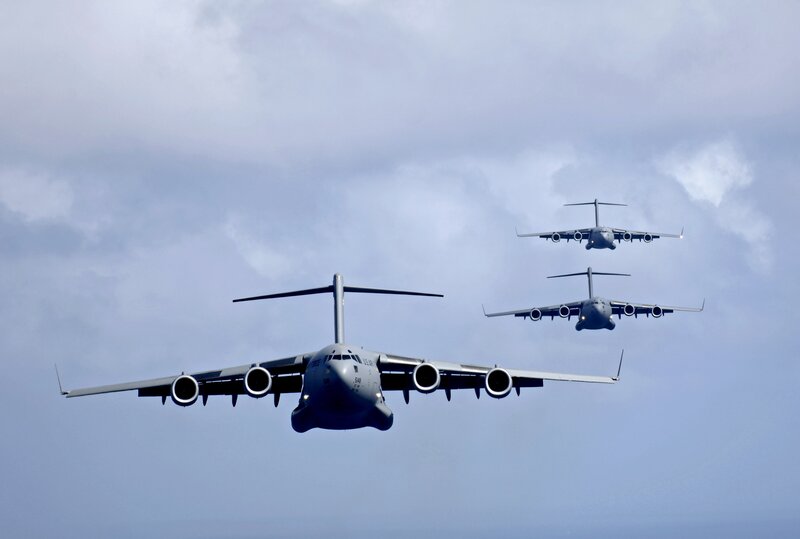 Three military transport planes in formation