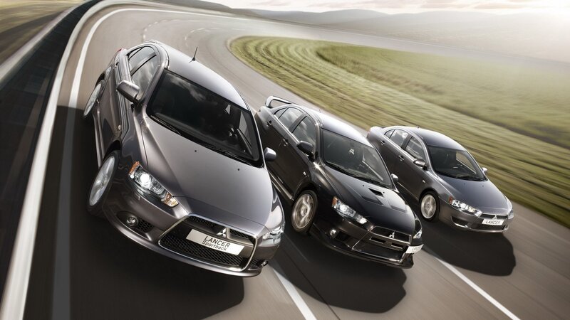 Three Mitsubishi Lancer cars on a road