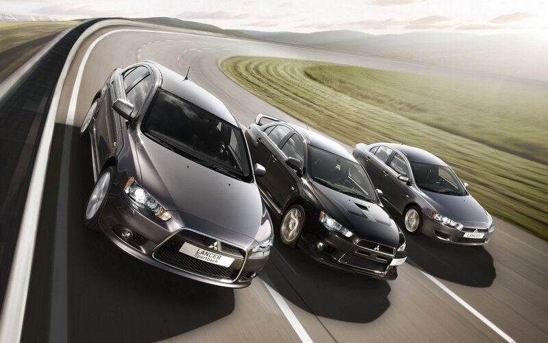 Three Mitsubishi Lancer cars on a road