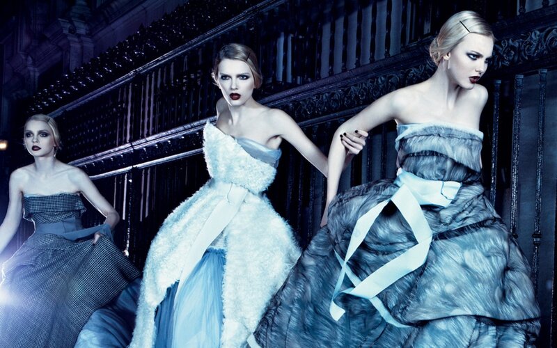 Three models in elegant gowns