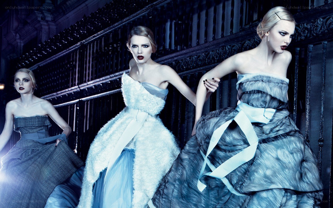 Three models in elegant gowns