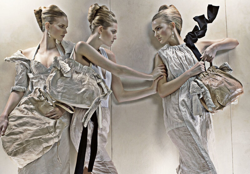 Three models with designer bags