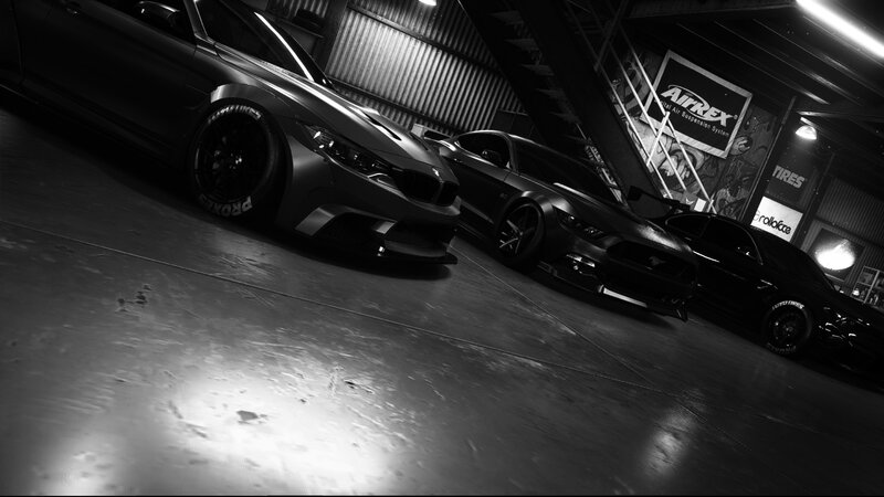Three Modified Cars in Garage — Black