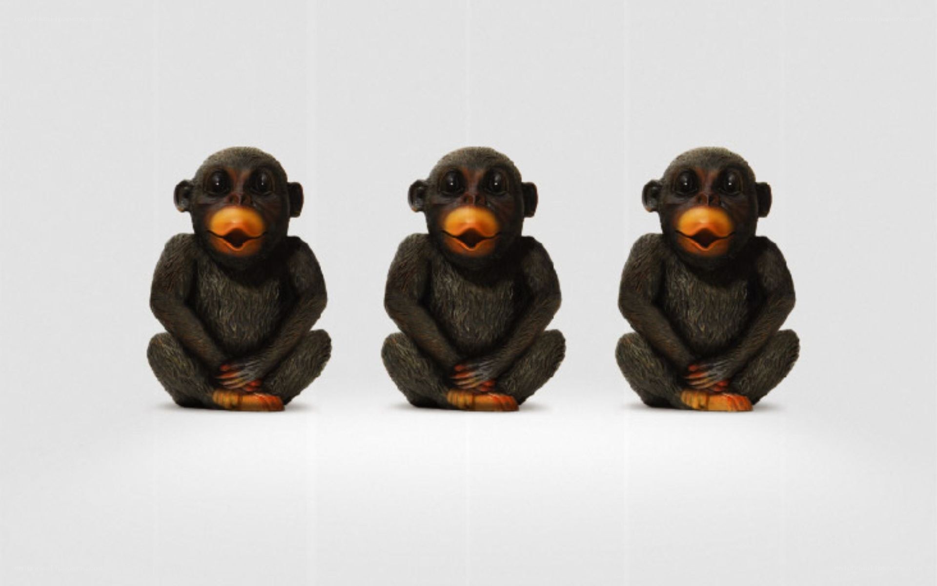 three monkey figurines