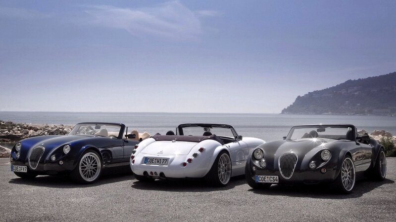 Three Morgan cars by the sea