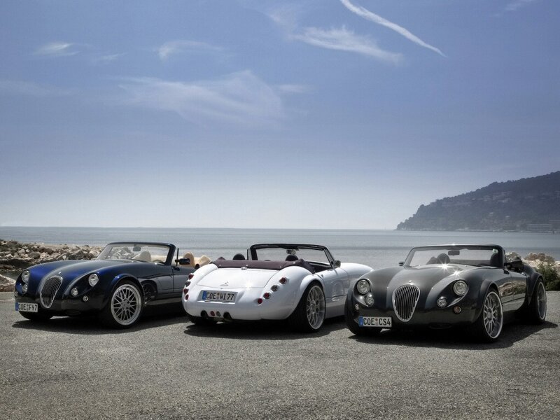 Three Morgan cars by the sea