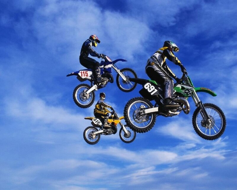 Three Motocross Riders in Mid-air