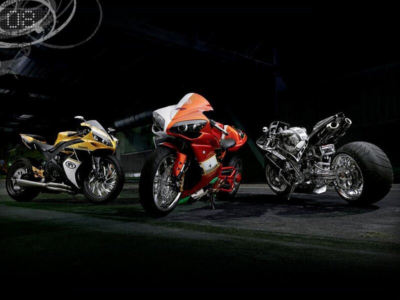 Three motorcycles in a dark garage