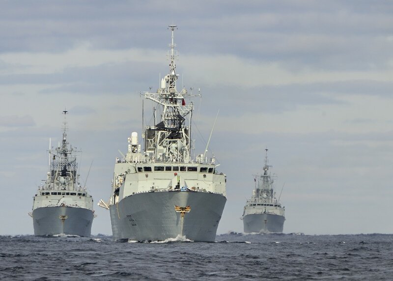 Three Naval Ships at Sea