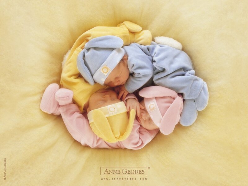 Three newborn babies sleeping