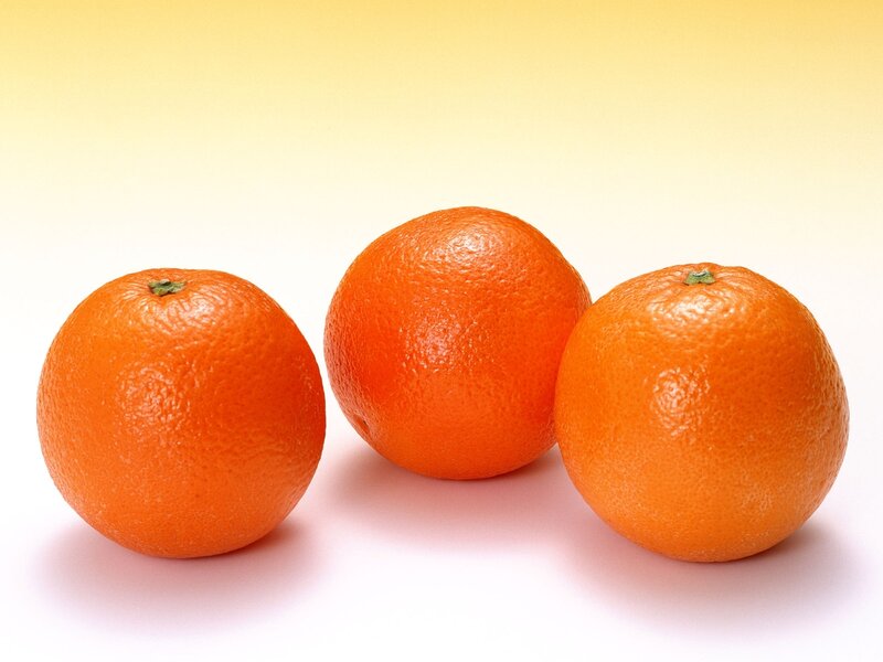 Three oranges on a white background
