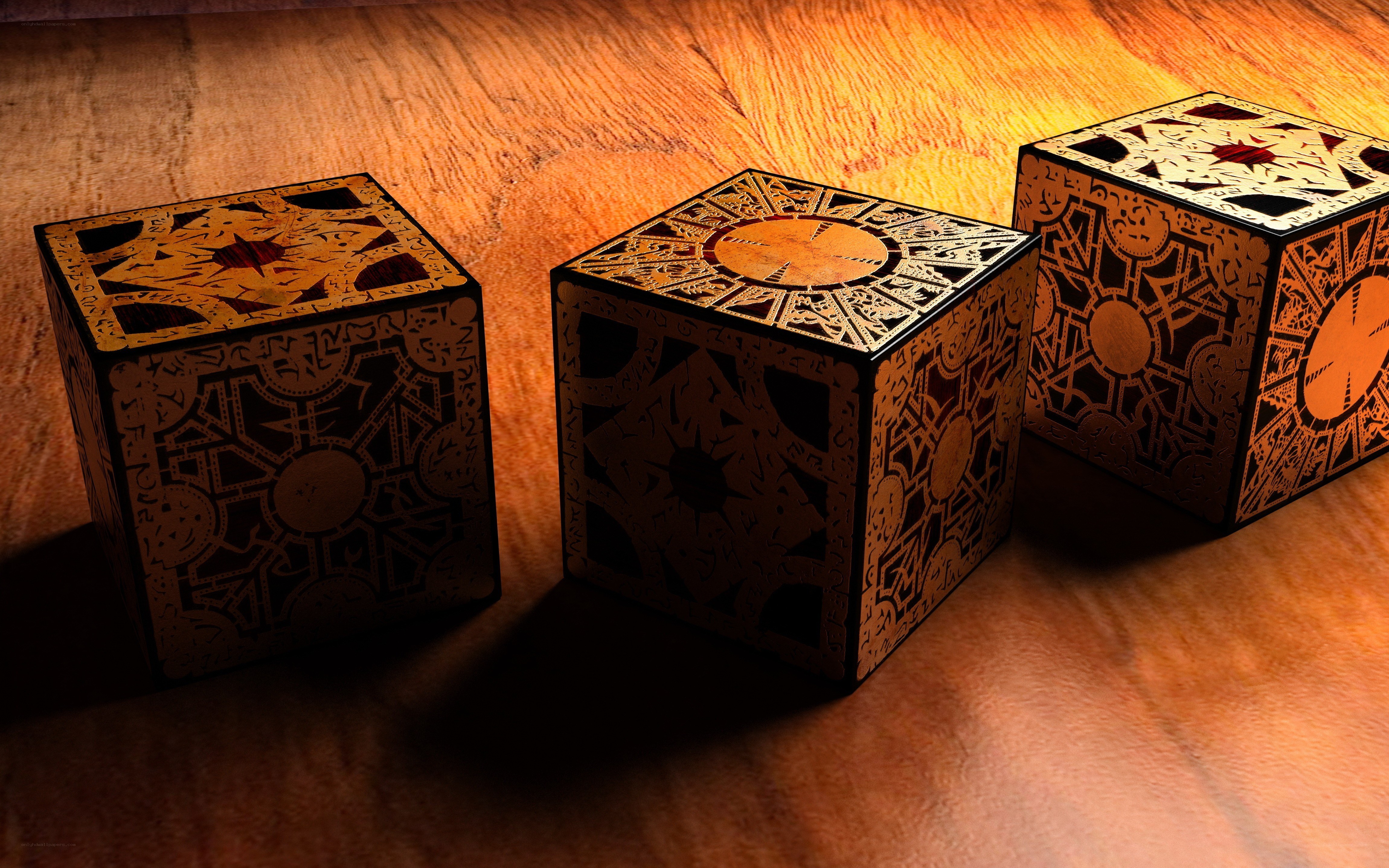 three ornate puzzle boxes
