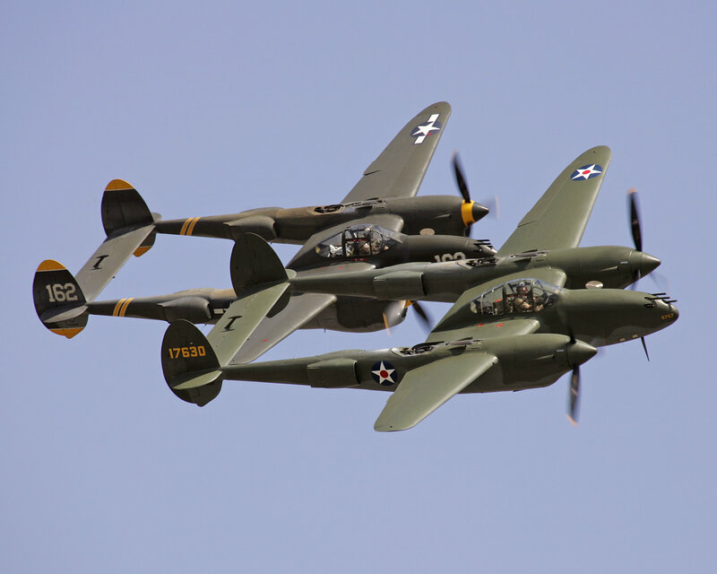 Three P-38 Lightning aircraft in formation