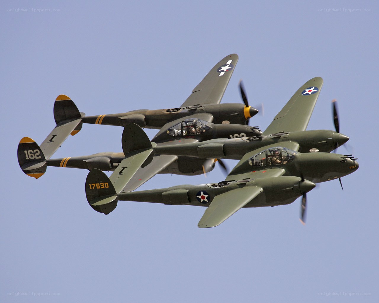Three P-38 Lightning aircraft in formation