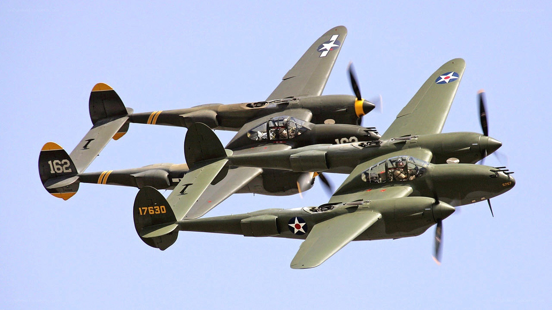 Three P-38 Lightning aircraft in formation