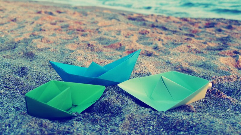 Three Paper Boats on Sand
