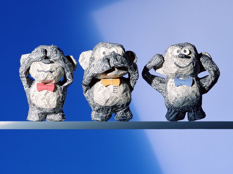 Three paper monkeys on a shelf