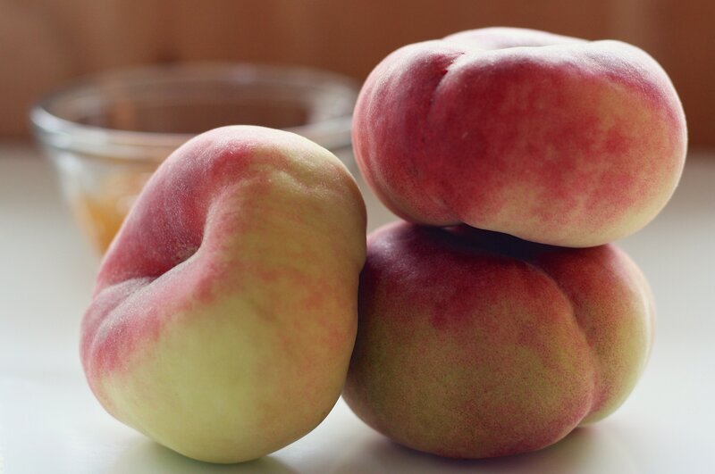three peaches on a table