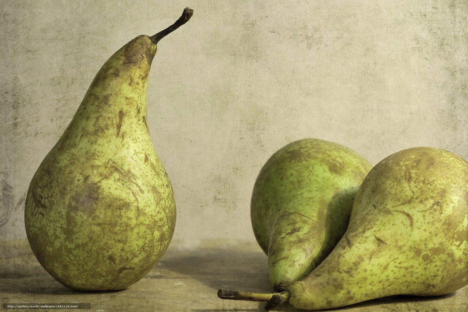 Three pears on a textured surface