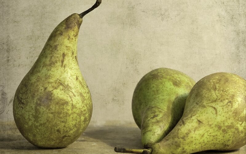 Three pears on a textured surface