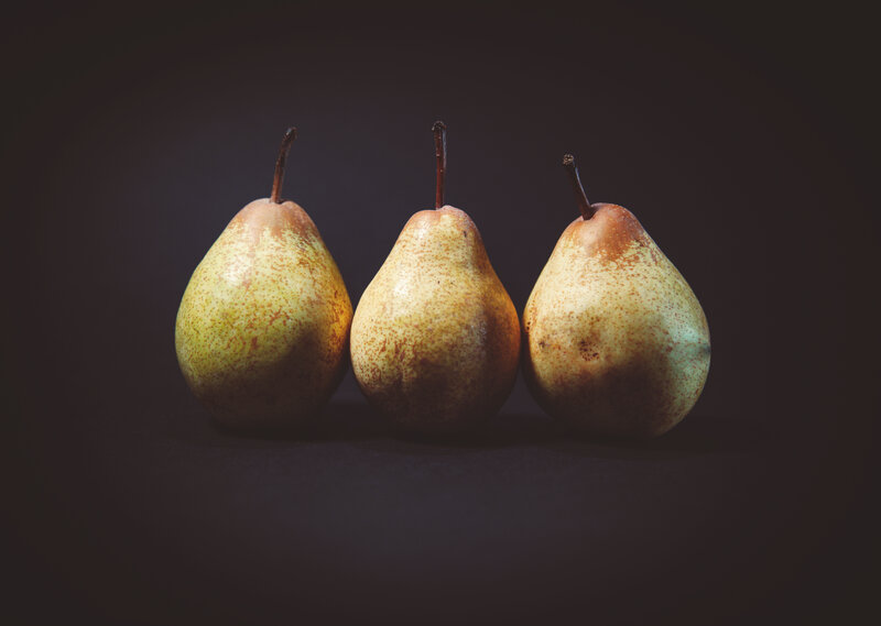 Three pears on dark background